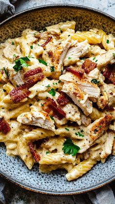 pasta with chicken, bacon and parsley in a bowl