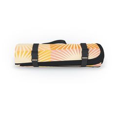 an orange and yellow duffel bag sitting on top of a white surface with black straps