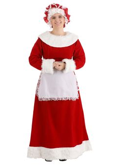 a woman dressed in a santa clause outfit and holding a white apron with red trim