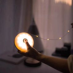 a person holding a light in their hand