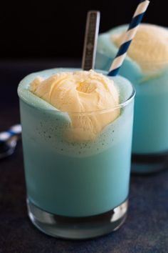 two glasses filled with ice cream on top of a table