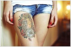 a woman's legs with tattoos on them and an owl tattoo on the thigh