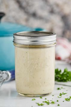 homemade chicken soup in a mason jar with parsley on the side