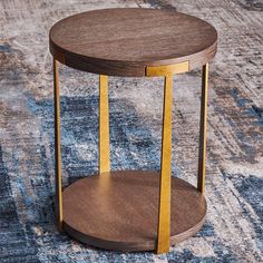 a round wooden table sitting on top of a rug