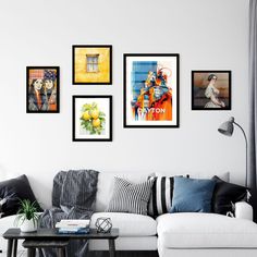 a living room filled with furniture and pictures on the wall above it's coffee table