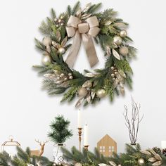 a christmas wreath on top of a mantle