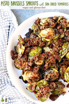 a white plate topped with brussel sprouts and sun dried tomato sauce