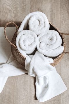 white towels in a basket on the floor