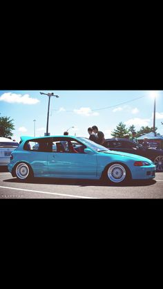 a blue car parked in a parking lot