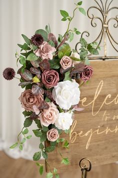 a bouquet of flowers sitting on top of a wooden sign