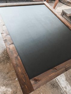 a large blackboard sitting on top of a wooden table