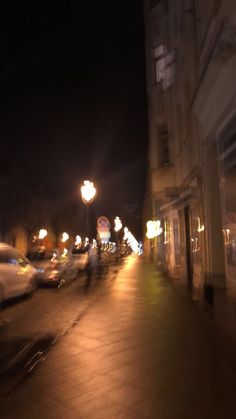 blurry image of cars driving down the street at night