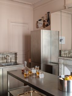 a kitchen filled with metallic appliances and lots of counter top space next to a sink