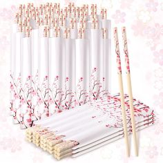 six white chopsticks are lined up next to each other with cherry blossoms on them