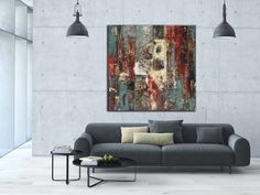 two paintings hanging on the wall above a couch