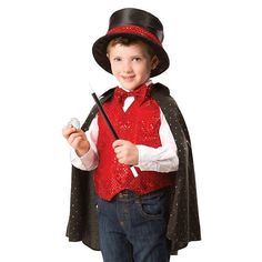 a little boy dressed in a red vest and black top hat holding a cane while wearing a dracula costume