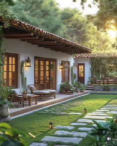 an outdoor patio with grass and stepping stones leading to the front door, covered in greenery