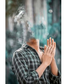 a man with his hands together in prayer while looking into the distance at an abstract background