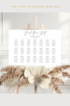 a wedding seating chart is displayed on a wooden easel with pamolite flowers