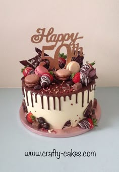 a birthday cake with chocolate and strawberries on top