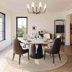 a dining room table with chairs around it and a chandelier hanging from the ceiling