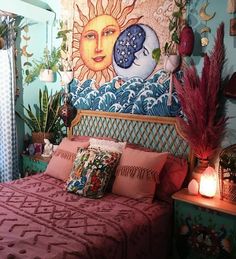 a bedroom decorated in blue and pink with sun on the wall above the headboard