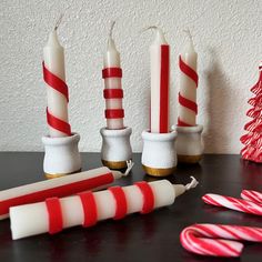 This listing is for a Set of 6 Festive Candy Cane Dinner Candles with Optional White Wooden Holders Add a touch of holiday magic to your dining table with this charming set of 6 dinner candles, each standing 4.5 inches tall. These beautifully crafted candles feature delightful designs inspired by the festive season, including classic candy cane stripes and elegant white candles adorned with red decorations in three unique patterns. Product Details: *Quantity: 6 dinner candles *Height: 4.5 inches each *Designs: Candy cane stripes, white with red decorations  *Optional Add-On: 6 white hand-painted wooden candle holders These candles are perfect for creating a warm and inviting atmosphere during holiday dinners, special occasions, or cozy nights in. The optional white wooden candle holders ad Painted Wooden Candle Holders, Red Decorations, Dinner Candles, Classic Candy, Candy Cane Stripes, Wooden Candle Holders, Wooden Candles, Red Decor, Candle Dinner