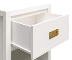 a close up of a white cabinet with two drawers and a gold handle on it