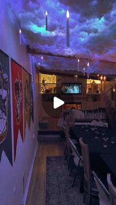 a dining room filled with tables and chairs under a cloudy sky above the television screen