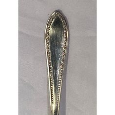 a silver spoon sitting on top of a white cloth