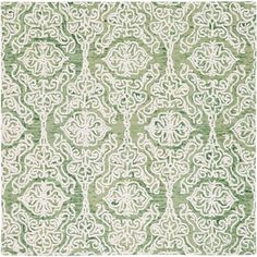 a green and white rug with an intricate design