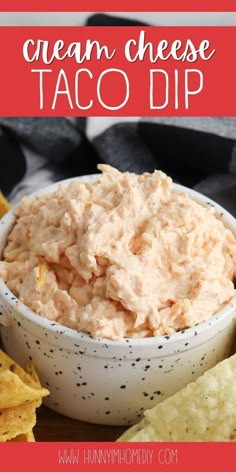 a white bowl filled with cream cheese taco dip surrounded by tortilla chips