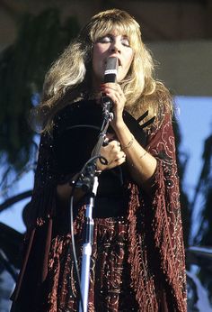 a woman standing in front of a microphone