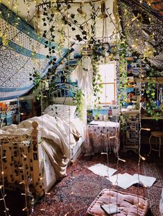 a bedroom with lots of plants hanging from the ceiling