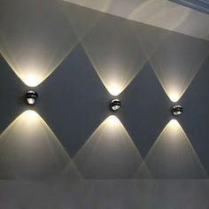 four lights are on the wall and one is lit up with white light from different angles