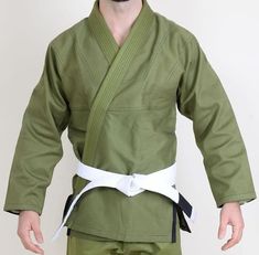 a man in a green kimono and white belt