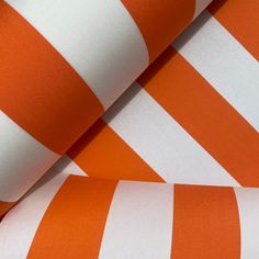 an orange and white striped fabric is shown in close up view, with the diagonal stripes visible