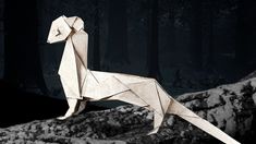 an origami animal standing on top of a rock in the woods at night