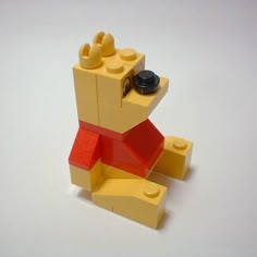 there is a small toy made out of legos and it looks like a bear