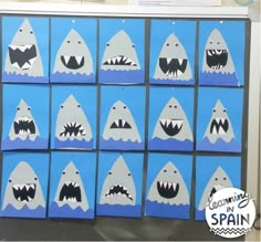 some blue boxes with white sharks painted on them and the words cut out in spanish