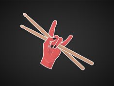 a hand holding two sticks making the peace sign