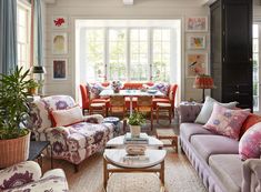 a living room filled with furniture and lots of windows