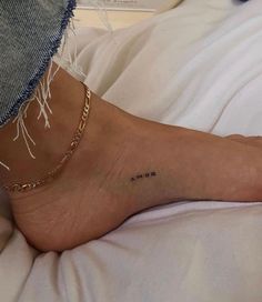 a woman's foot with the word mom written on it and a chain around her ankle