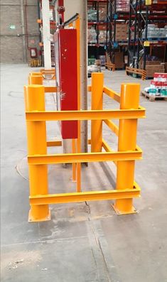 an orange and red object sitting in the middle of a warehouse