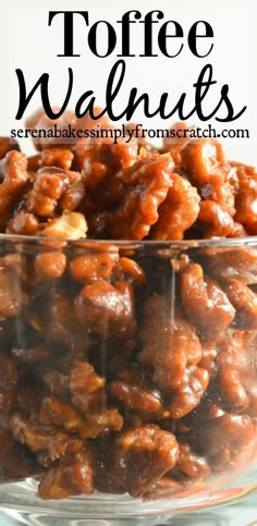 a glass bowl filled with walnuts on top of a table