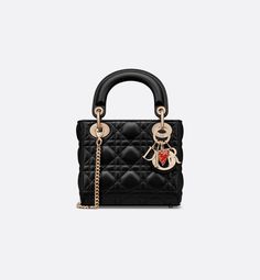 Part of the Dioramour capsule, the Lady Dior bag embodies the House's vision of elegance and beauty. Sleek and refined, the timeless design is crafted in black lambskin with Cannage stitching, creating the instantly recognizable quilted texture. The silhouette is elevated by pale gold-finish metal D.I.O.R. charms and a red enamel heart charm. The miniature style has a thin, removable chain strap, allowing it to be carried by hand or worn crossbody. It will coordinate well with other Dioramour cr Lady Dior Micro, Micro Lady Dior, Micro Bag, Satin Bags, Dior Fashion, Backpack Tote Bag