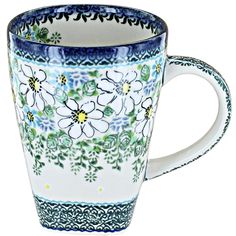 a blue and white coffee cup with flowers on it