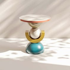 a white and blue vase sitting on top of a table