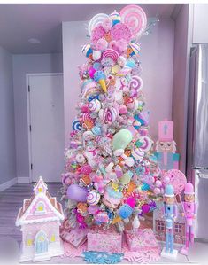 a pink christmas tree decorated with lollipops, candy and other candies