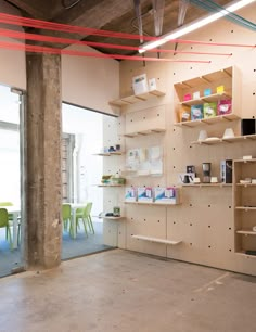 an empty room with shelves and chairs in it